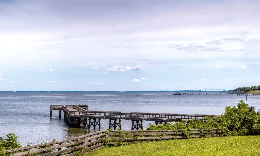 wooden harbor along a grassy shoreline leading out to the water on a sunny day is a great place to visit after getting your medical card