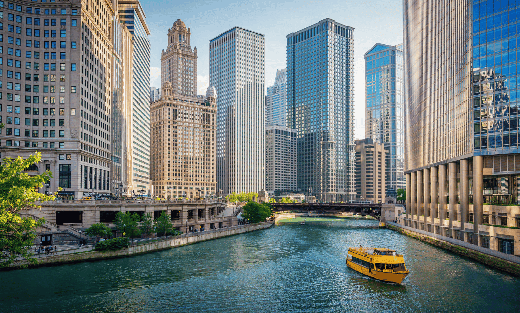 chicago river surrounded by buildings with yellow water taxi is a great place to visit after getting your medical card