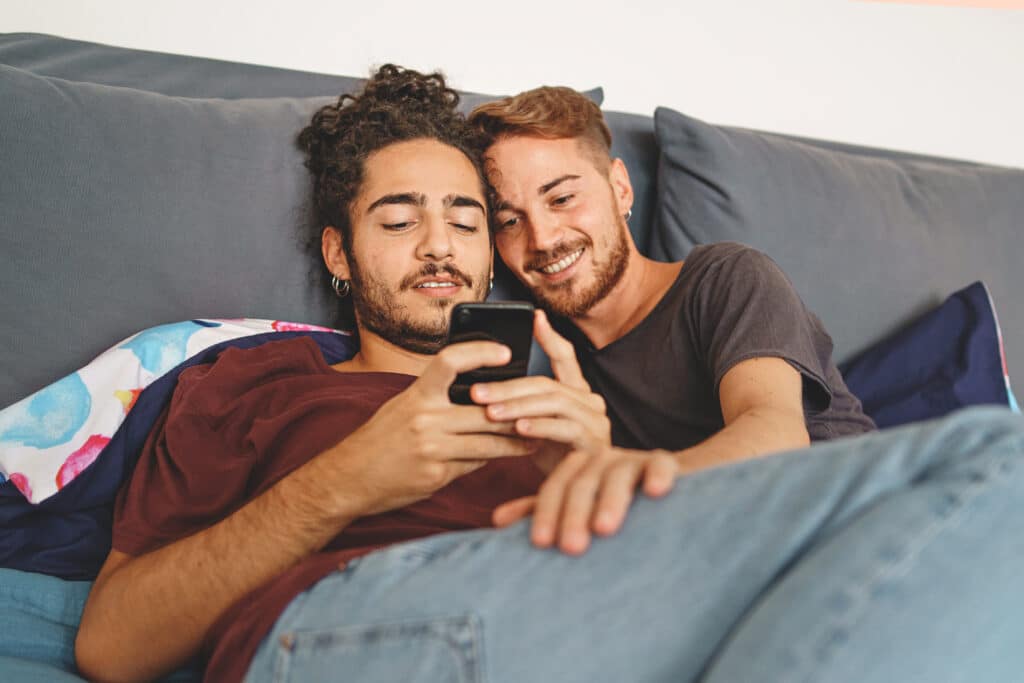 gay couple sitting on the couch getting medical marijuana card online in minutes
