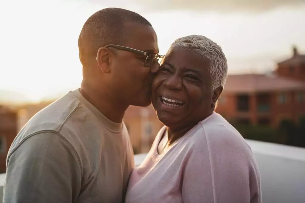 happy black couple having tender moment after getting approved for medical cannabis card