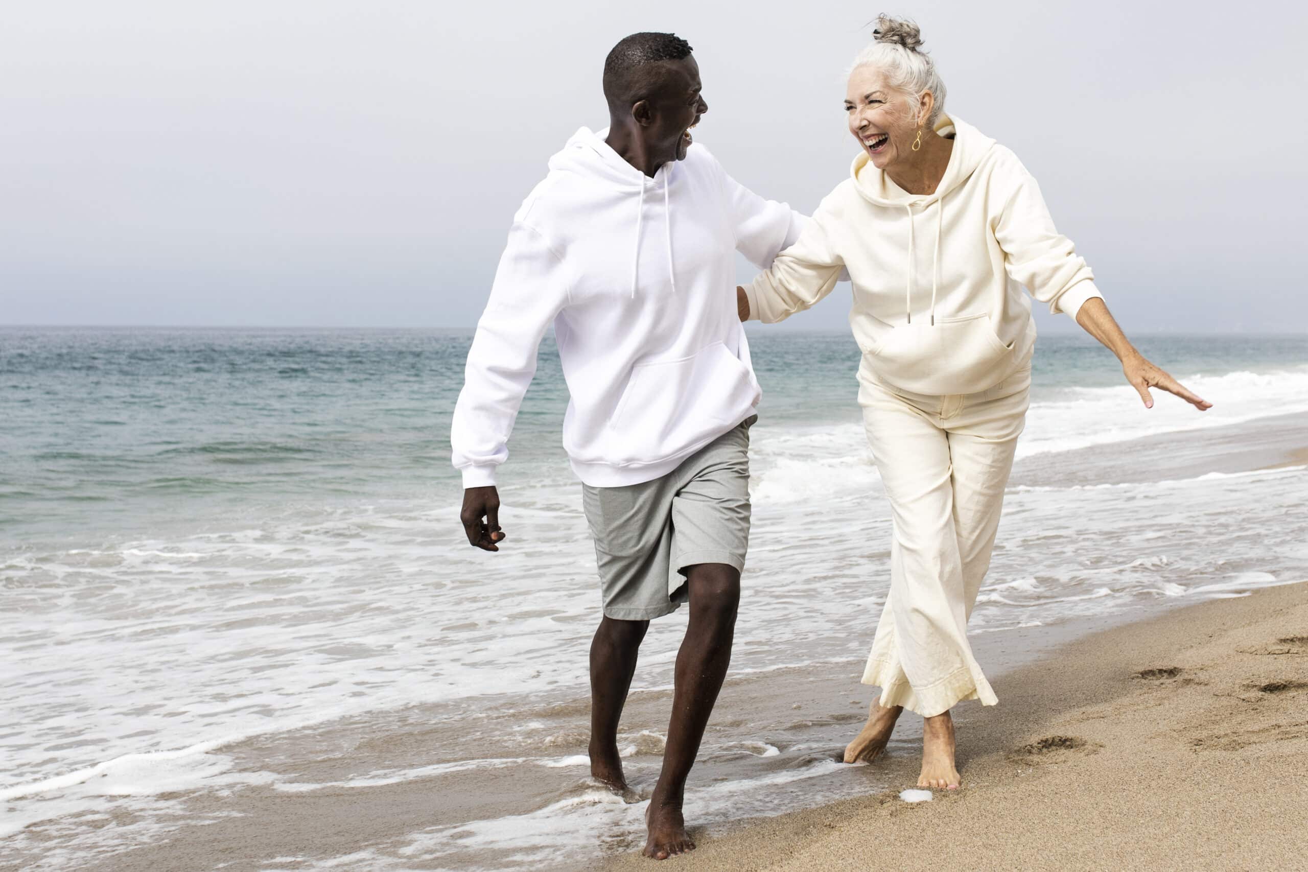 Happy senior couple relaxing at the beach after meeting with cannabis coach