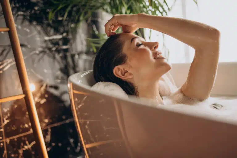 Women relaxing in a bath using thc bath bombs