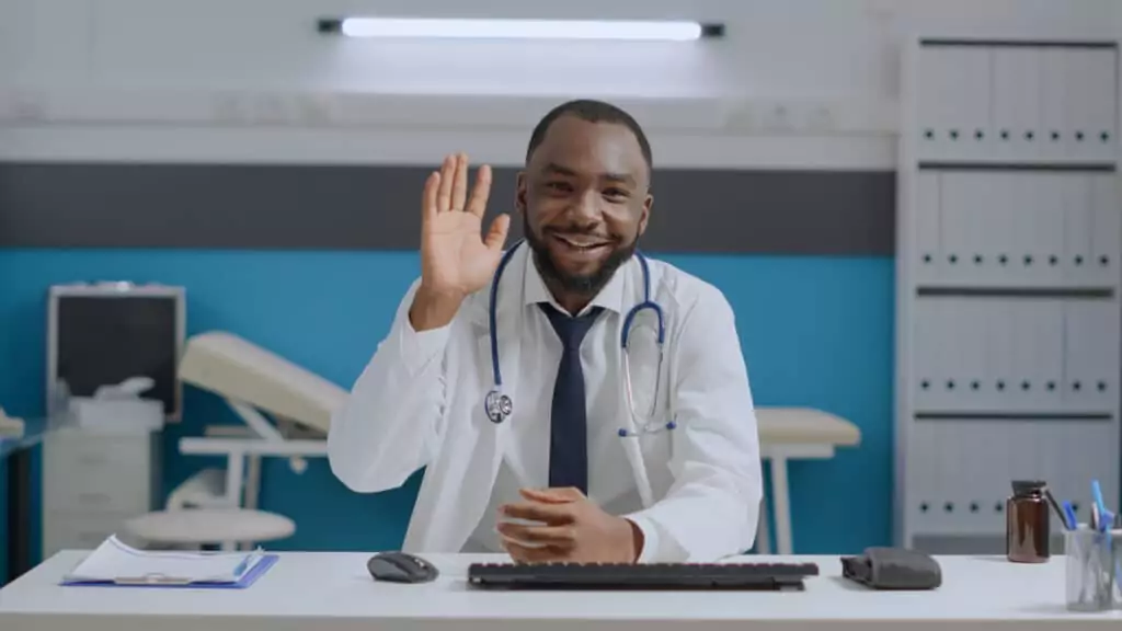 pov of african american specialist doctor sitting at desk in hospital office