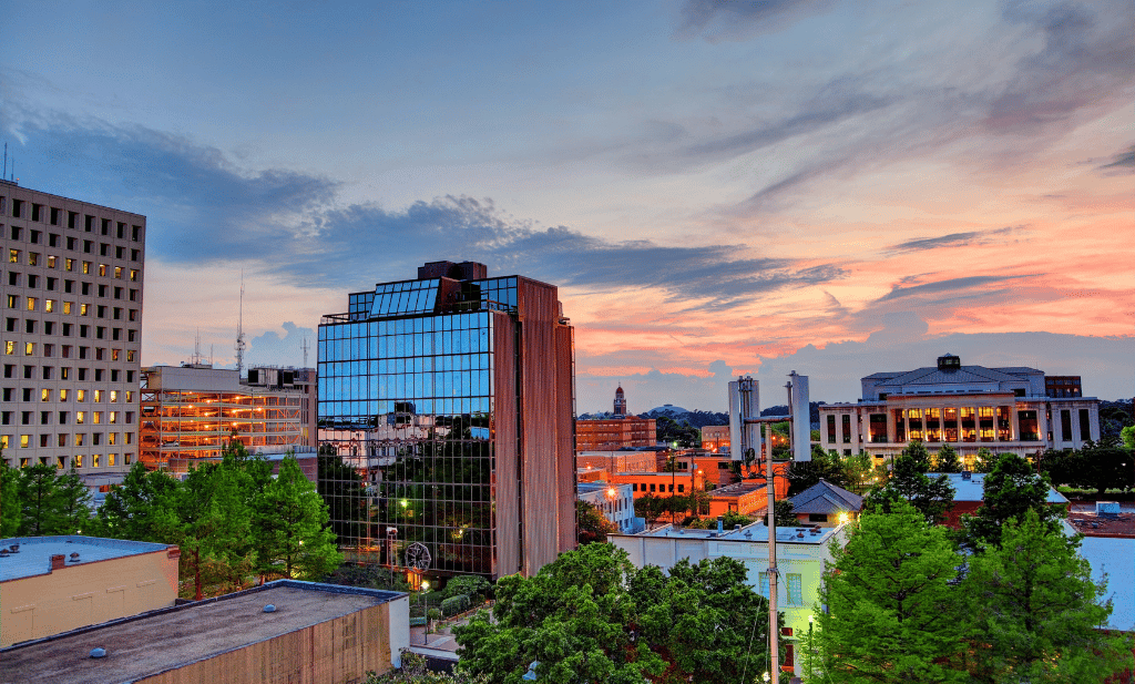 Downtown buildings and trees at dusk in lafayette louisiana is a great place to visit after getting your medical card