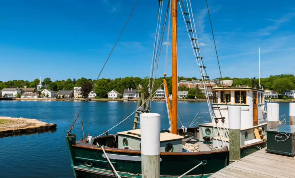 Large sailboat in the harbor with houses and trees in the background is a great place to go after you get your medical marijuana card