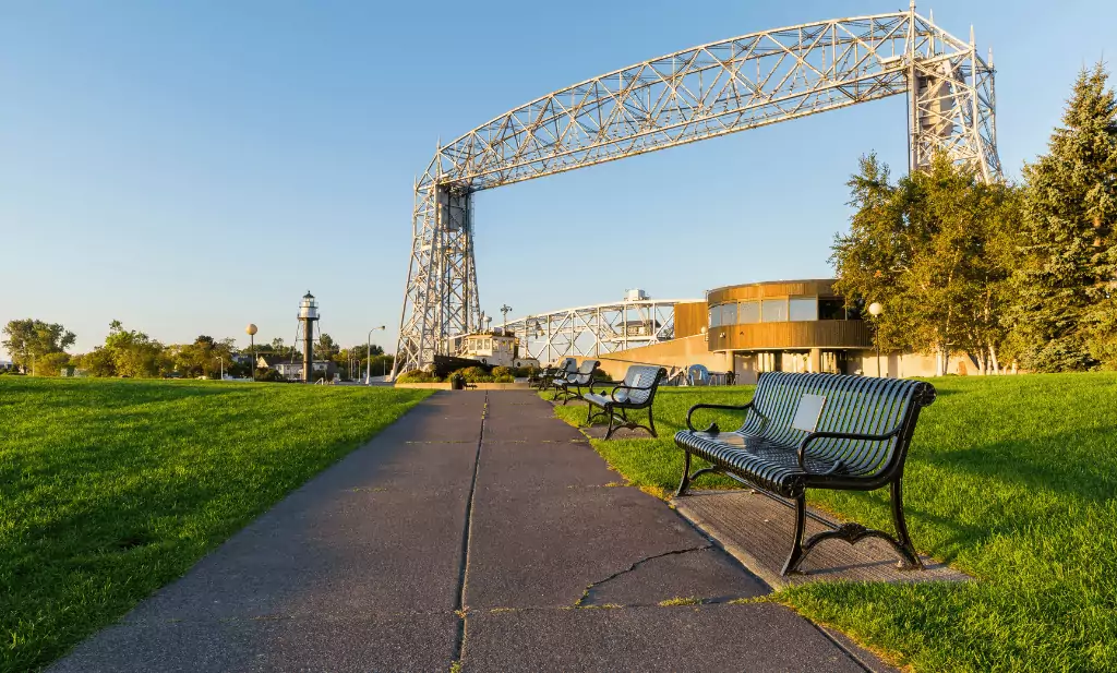 sidewalk with park benches leading towards a lift bridge in Canal park at the beginning of the North Shore Scenic drive is a great place to go after getting approved for a medical card