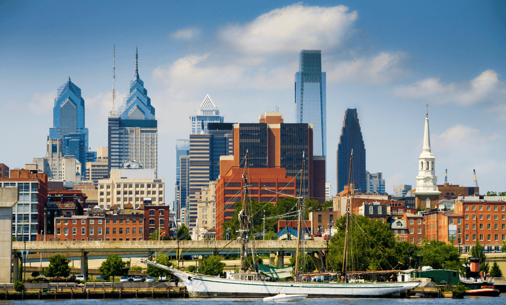 water's edge of philadelphia with buildings and large sailboat is a great place to visit after getting your medical card