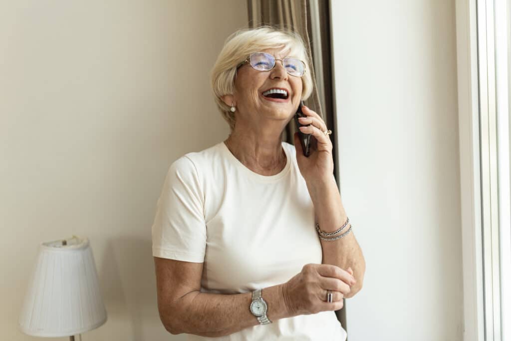 senior woman renewing medical marijuana card on the phone