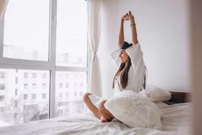 woman in bed wearing sleeping mask after a restful night using CBN