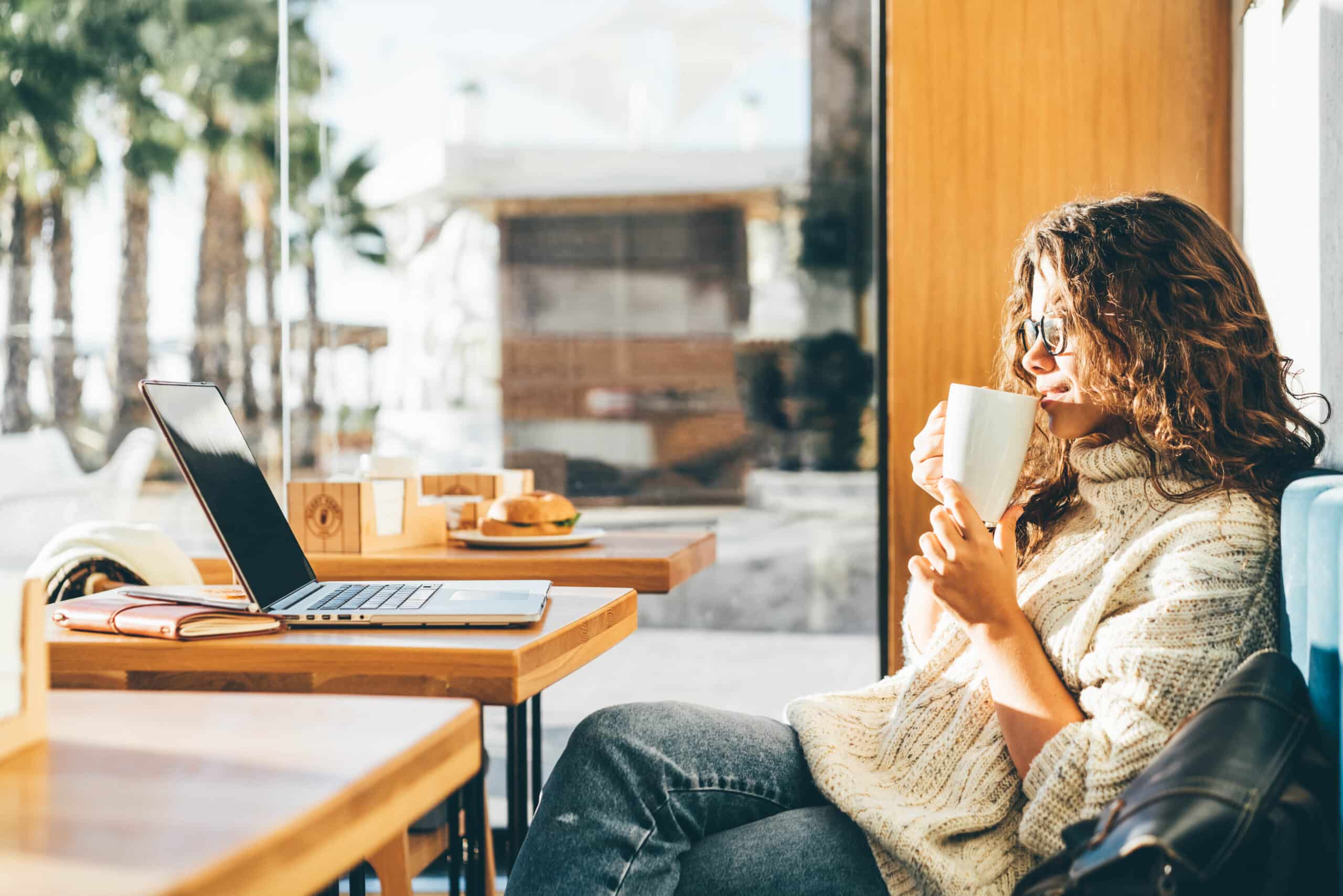 Woman relaxing in coffee shop after getting approved for medical cannabis card
